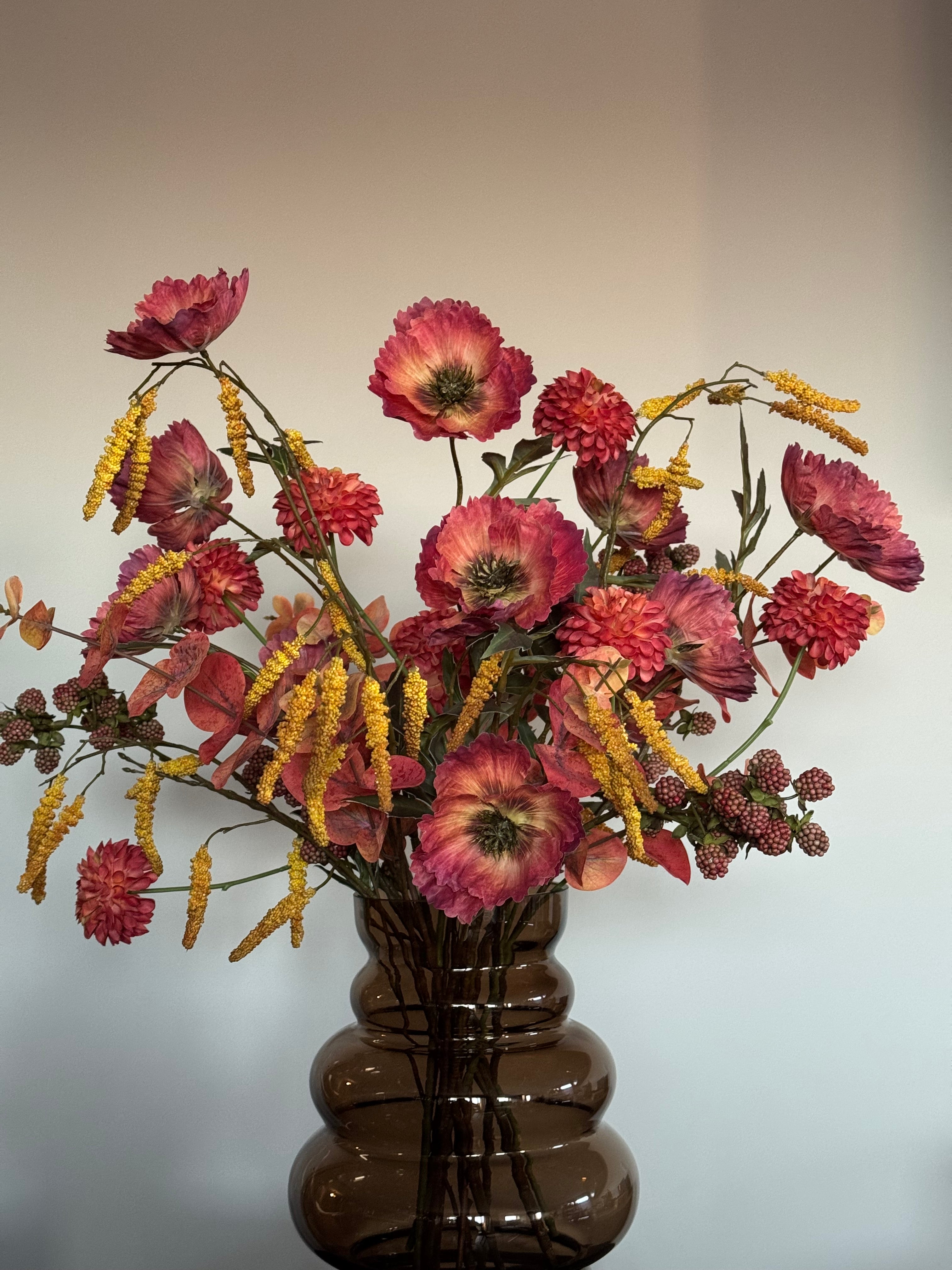 zijden bloemen met vaas warme tinten close up